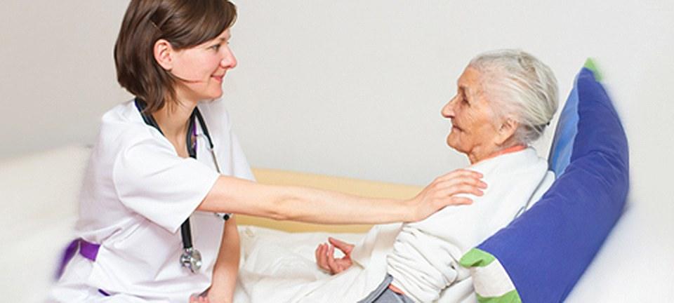 A nurse with an older woman at home